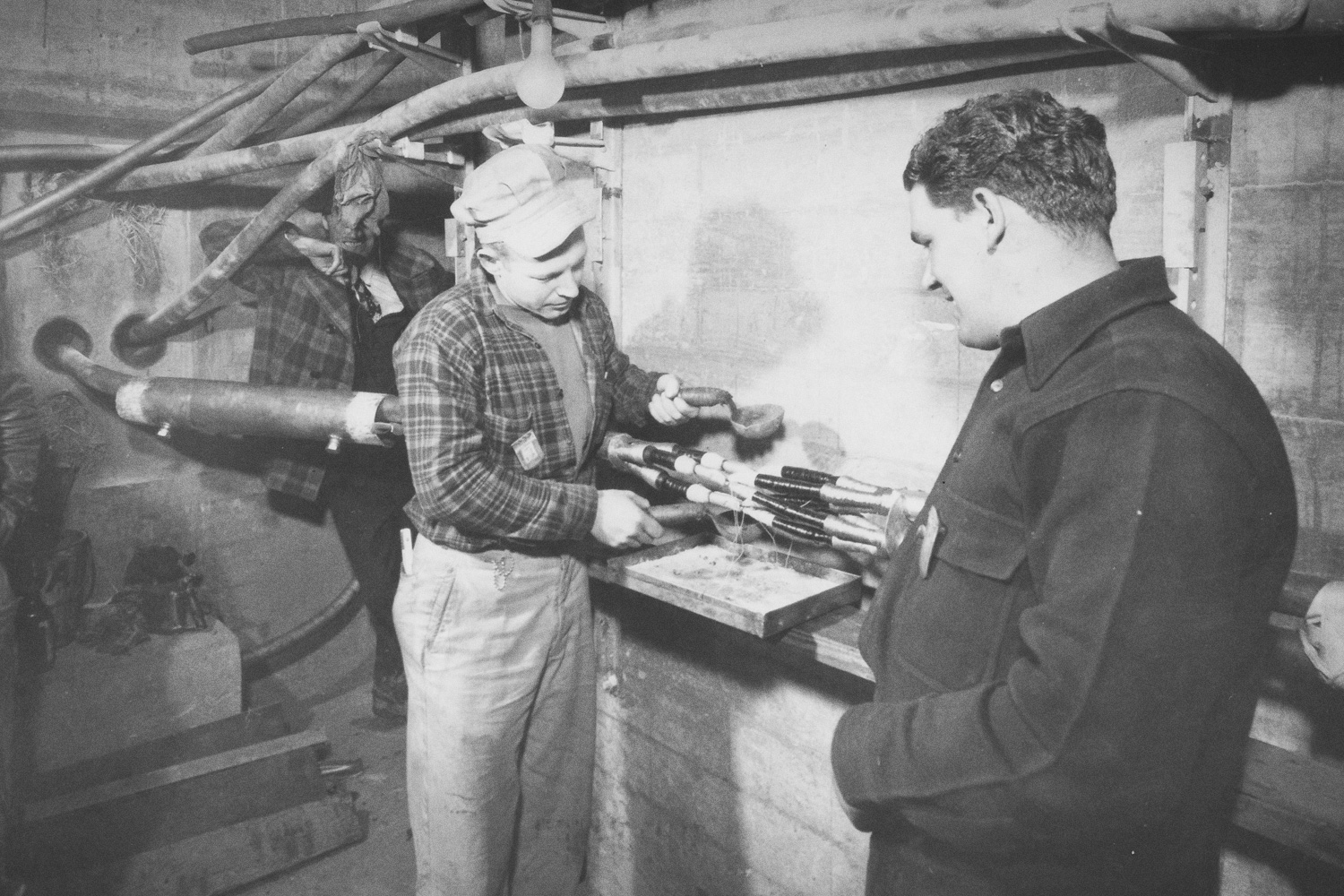 Electrician splicing underground electrical cable that supplied electricity to K-25 Building, March 5, 1945